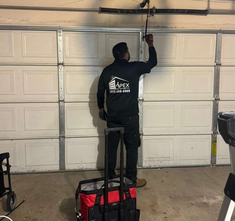 Annual garage door maintenance inspection in McKinney TX by Apex Garage Pro technician