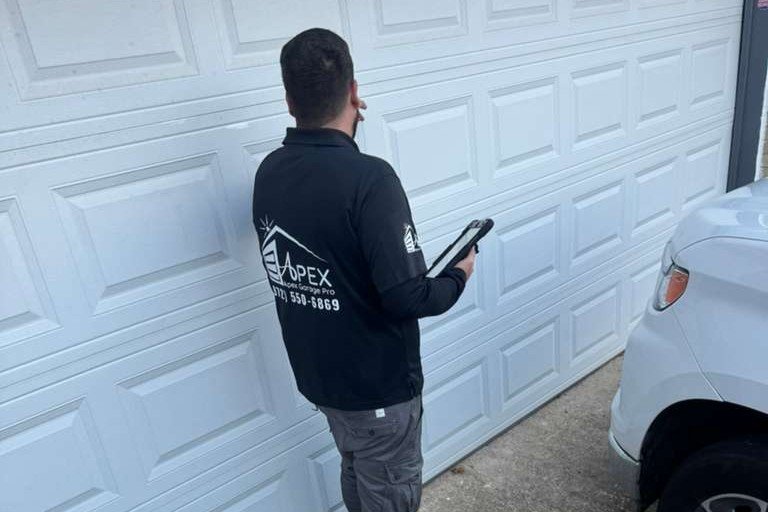 Garage door panel replacement inspection by Apex Garage Pro in McKinney TX