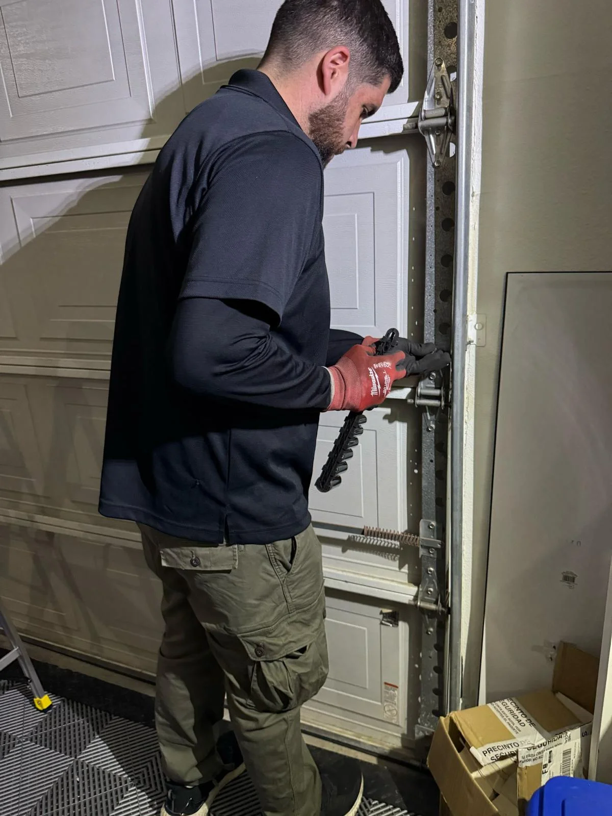 Garage Door Repair in Melissa responding to emergency breakdown with technician repairing a stuck garage door in Melissa, Texas
