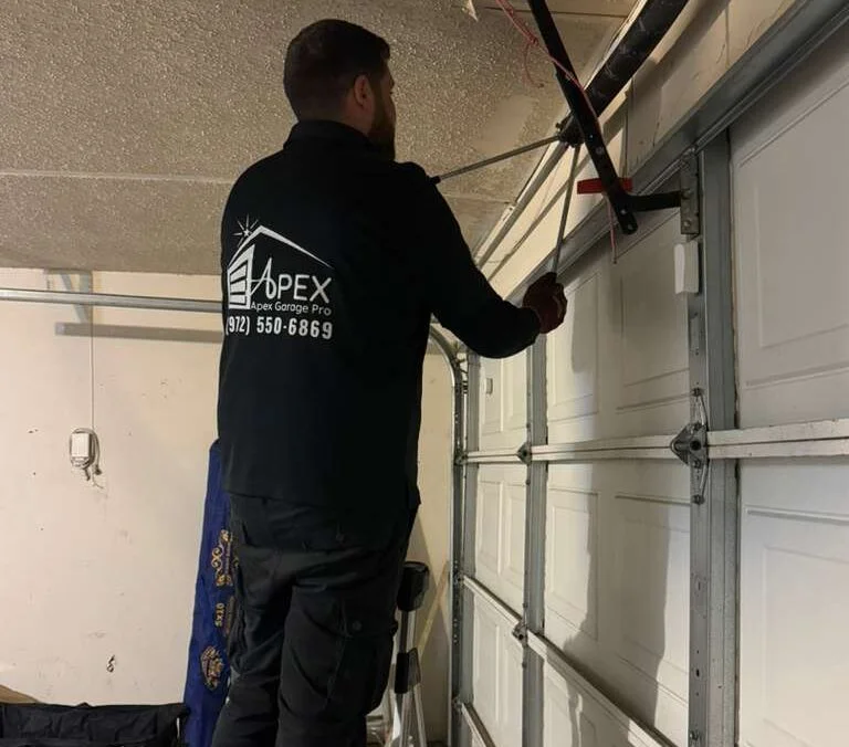Expert handling Garage Door Fix for broken torsion spring in garage door mechanism