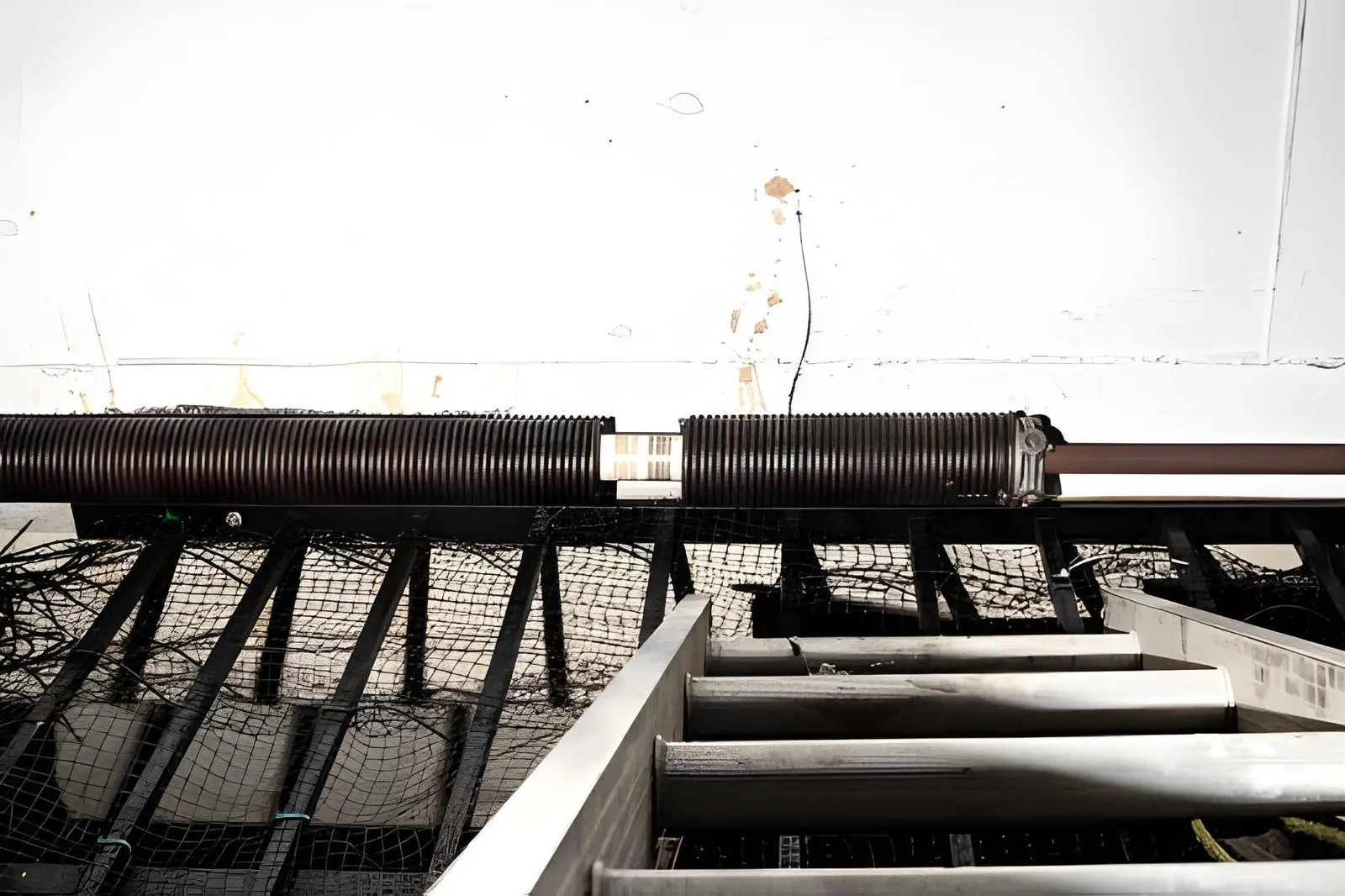 Garage Door Spring Replacement process installing new high-tension springs for balanced door lifting