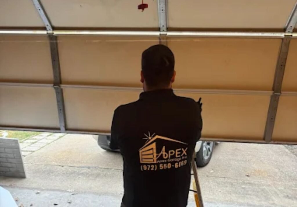 Apex Garage Pro technician inspecting an open garage door